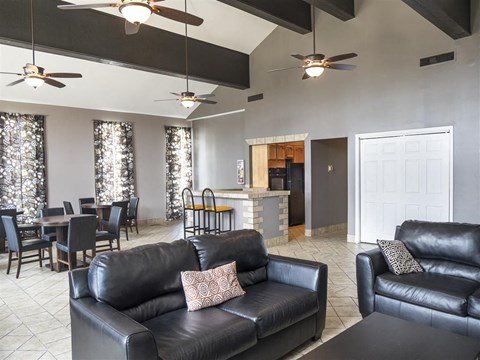 a living room and dining room with leather couches and a table