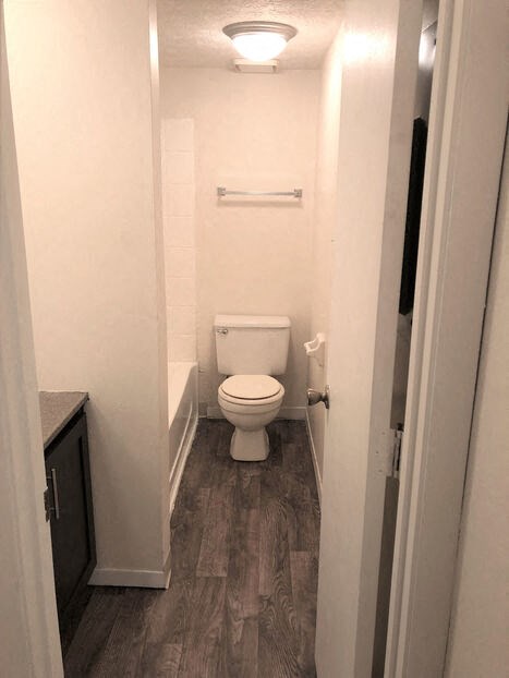 a small bathroom with a toilet and a bath tub