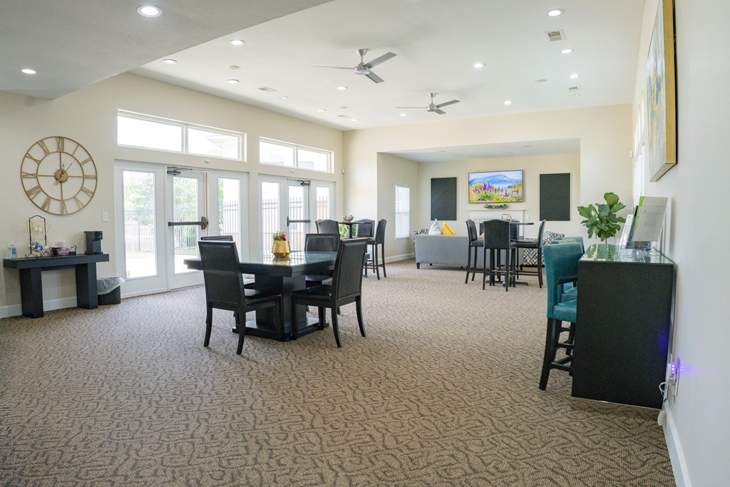 A living room with a dining table and chairs.