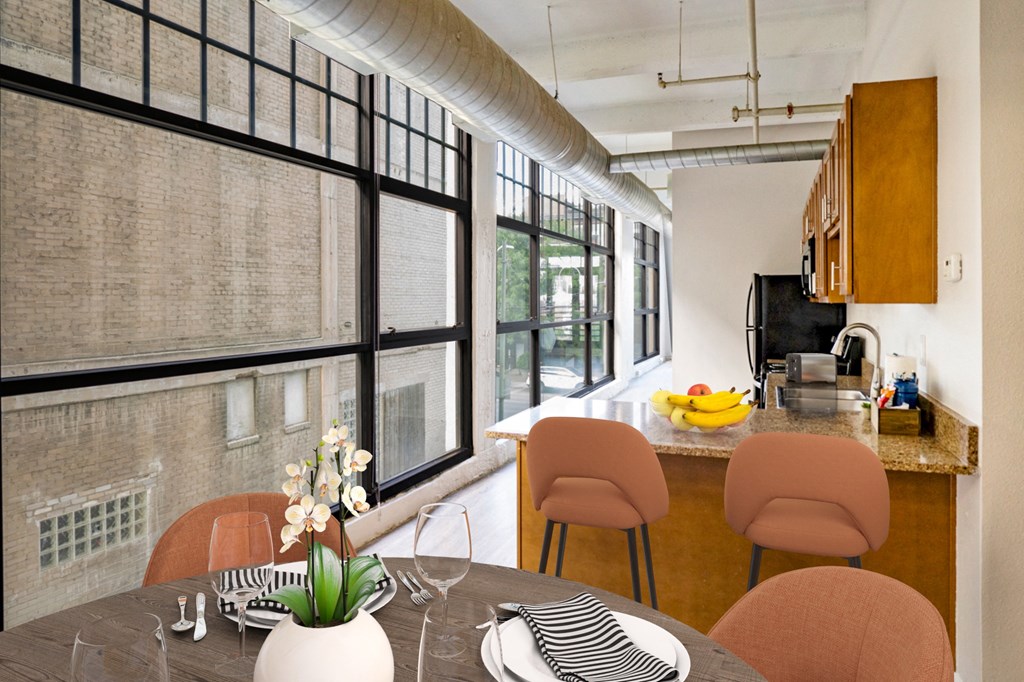 Open kitchen and dining area with wall of windows allowing for lots of natural lighting at St. Clair Lofts in Dayton, OH