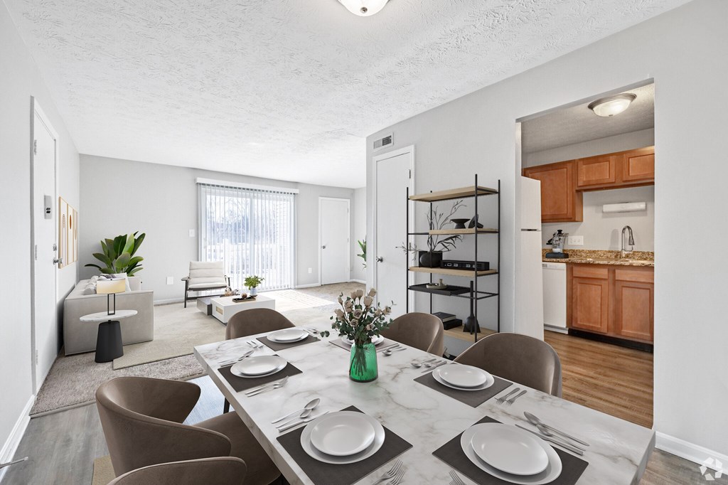A dining room with a table set for four.