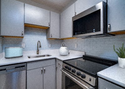 a kitchen with a stove and a sink and a microwave