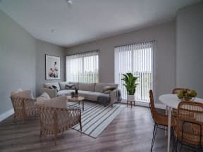 a living room and dining room with a table and chairs