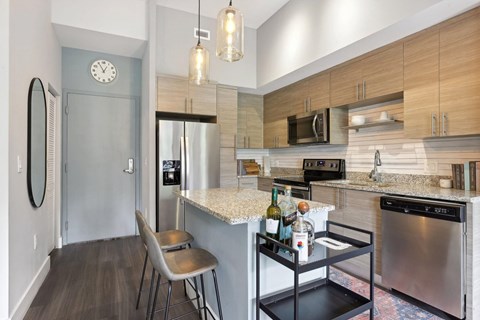 A kitchen with a stainless steel dishwasher and a white countertop.