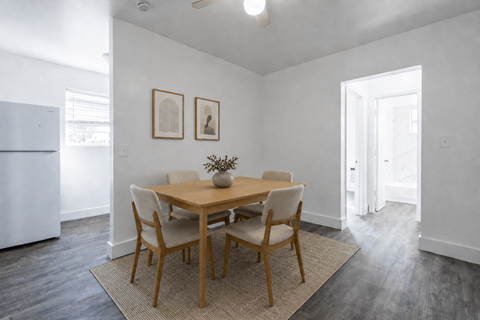 A dining room with a table and chairs.
