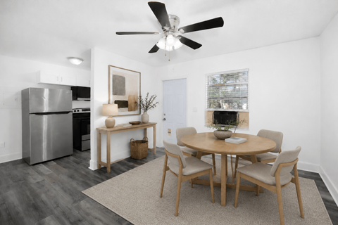 A modern dining room with a table set for six.