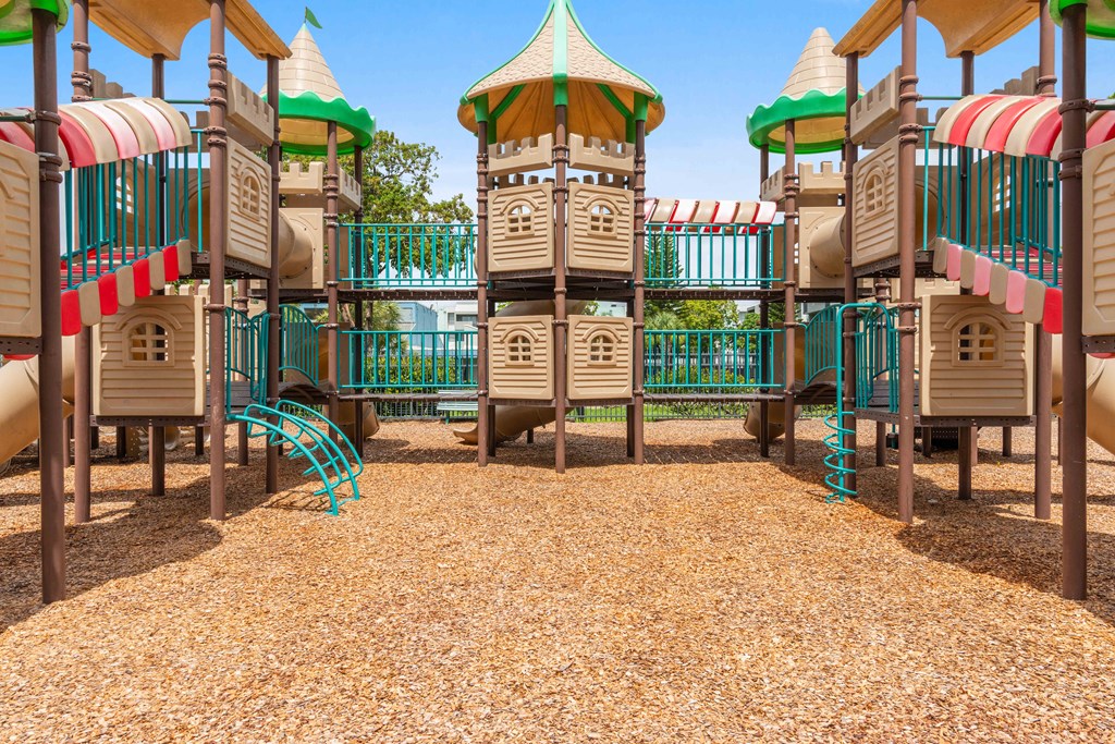A playground with a wooden structure and a slide.