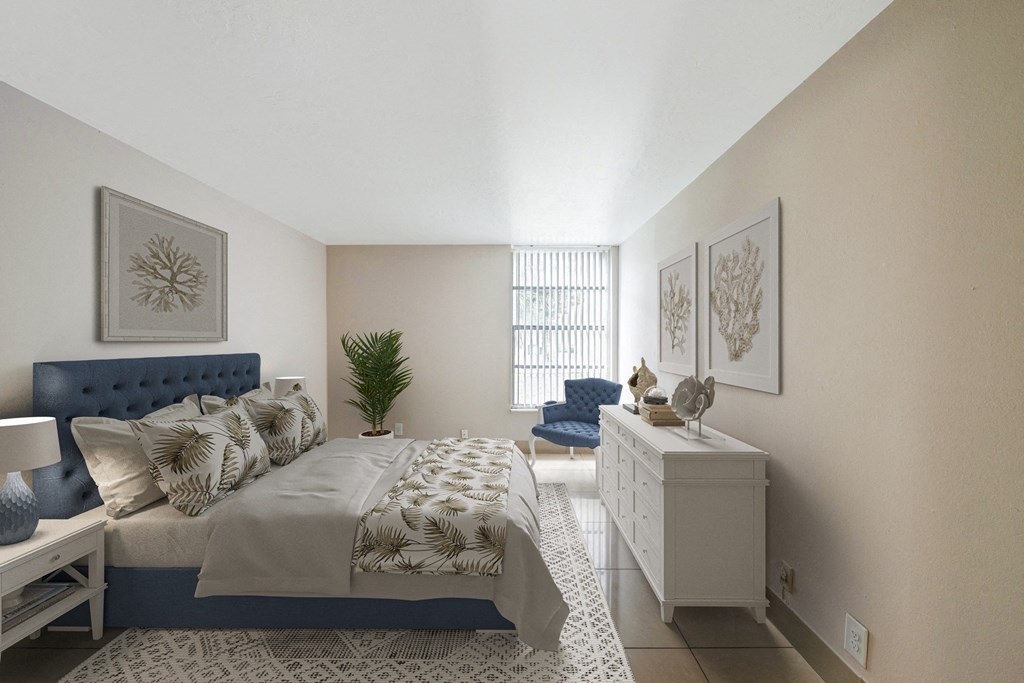 A bedroom with a large bed and a blue headboard.