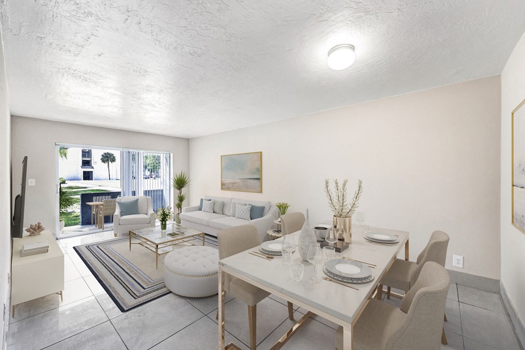 A dining room with a white table and chairs.