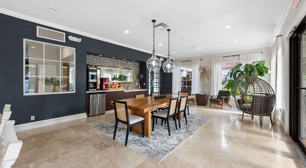 A dining room with a wooden table and chairs.
