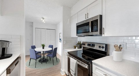 A modern kitchen with a table and chairs.
