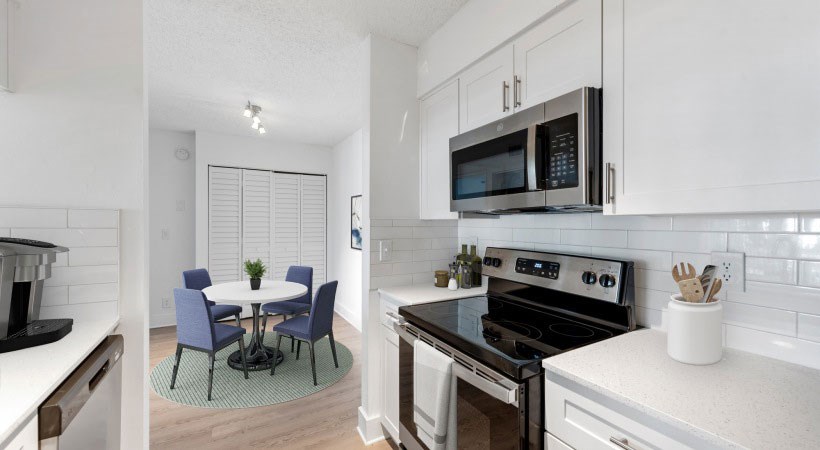 A modern kitchen with a table and chairs.