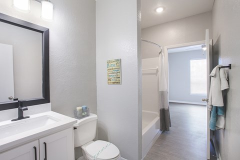 Bathrooms in newly renovated suite with quartz countertops and hardwood-inspired flooring (Legacy Series)