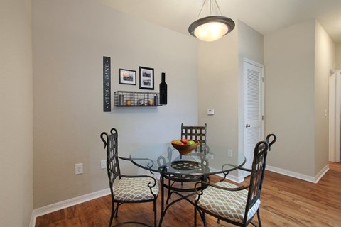 Dining room with overhead lighting and hardwood-inspired flooring (Signature Series)