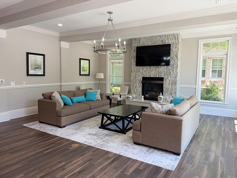 A living room with a fireplace and a television.