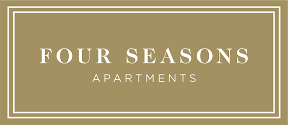 A sign that says "FOUR SEASONS APARTMENTS" on a beige background.