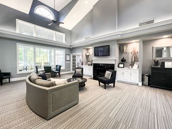 A living room with a grey sofa and a black chair.