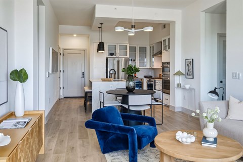 A blue chair is in the middle of a living room.