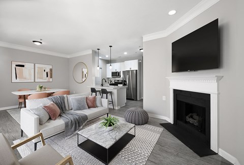 A living room with a fireplace and a television mounted above it.