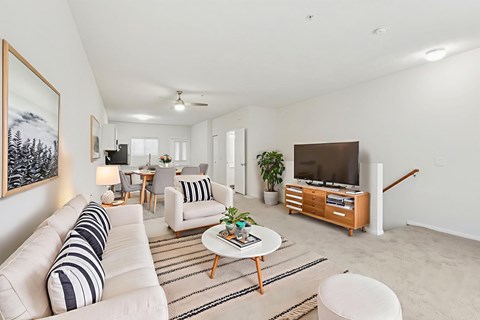 A living room with a white couch and a coffee table.