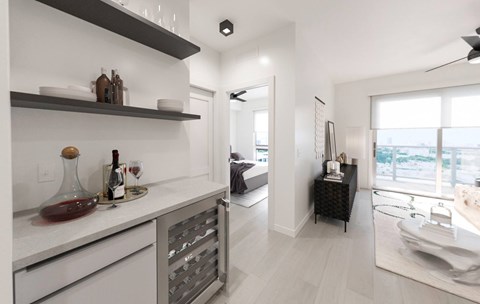 A modern kitchen with white cabinets and a marble countertop.