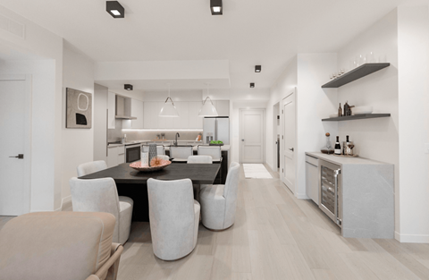 A modern kitchen with a dining table and chairs.
