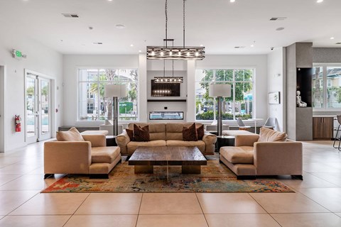A large room with a coffee table in the middle and a couch on each side.
