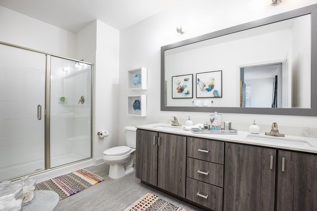 Large bathrooms with quartz countertops, dual vanities and walk-in showers