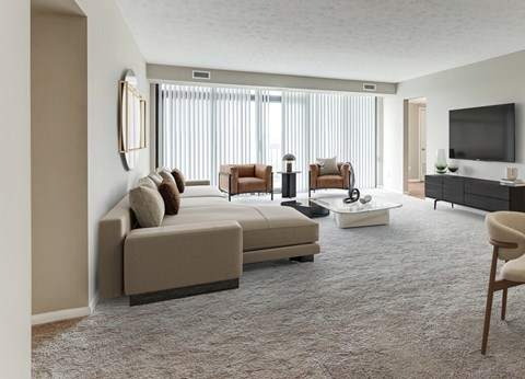 A living room with a large sectional sofa and a flat screen TV.