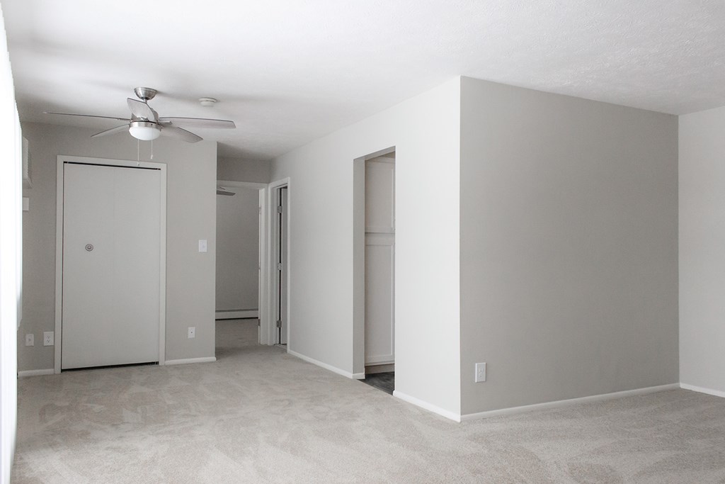 Living room with plush carpet and ceiling fan