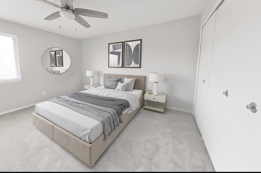 Main bedroom with ceiling fan and walk-in closet