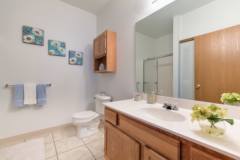 Bathrooms with tiled floors and walk-in showers