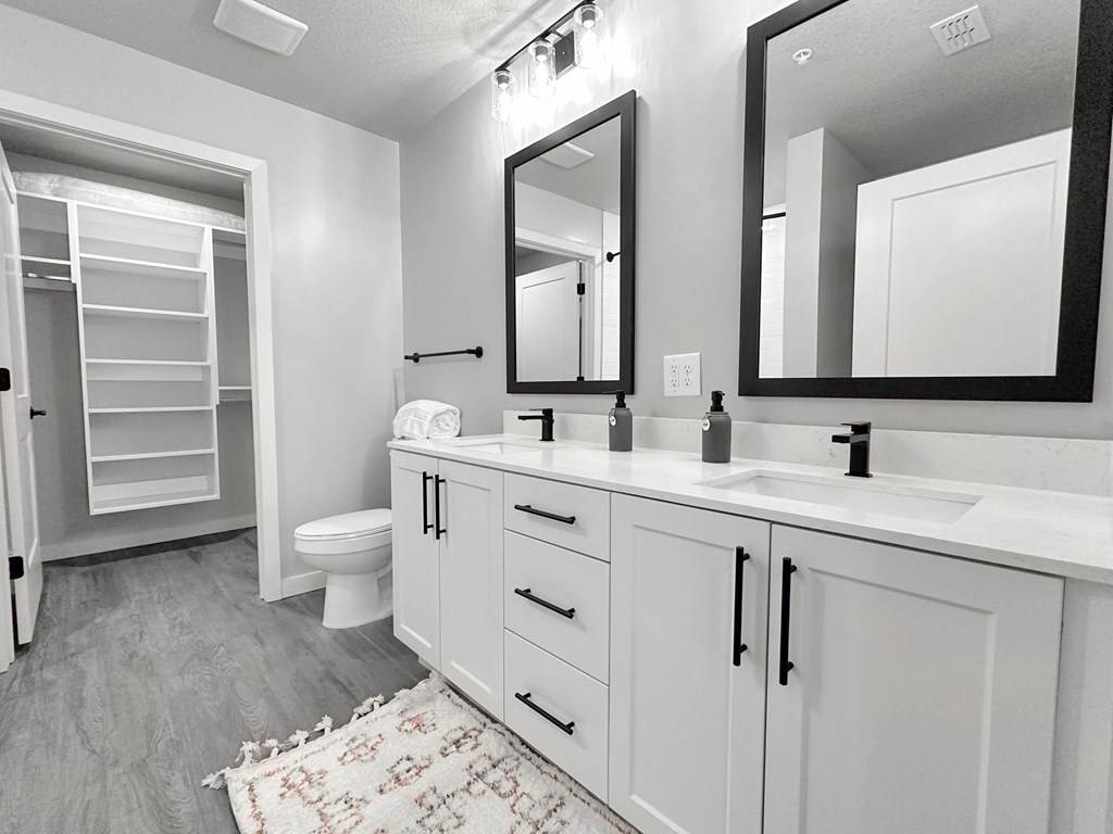 California-style walk-in closets, 42" white cabinetry, matte black fixtures and hardware