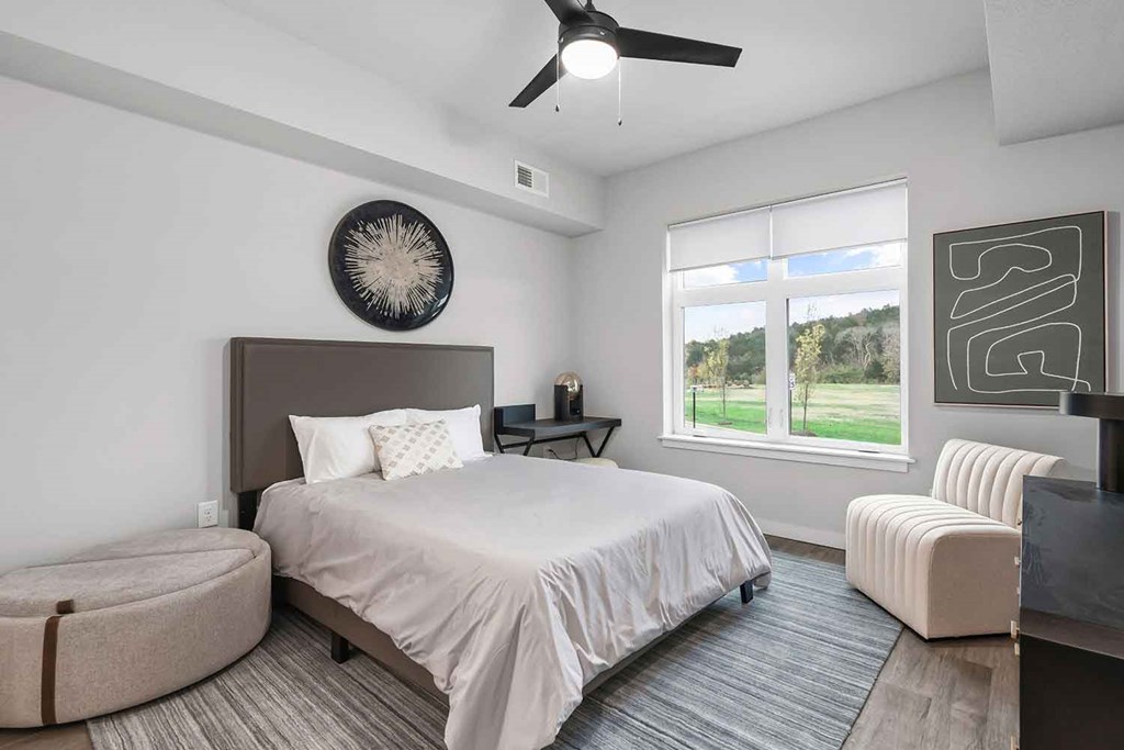 Bedrooms with overhead lighting and ceiling fan