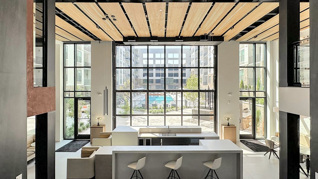 Impressive multi-story clubhouse with glass garage-style doors that open to outside