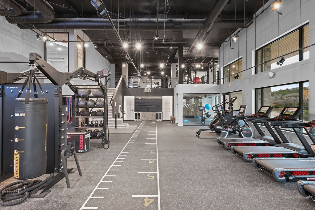 Cardio machines and weights in bi-level fitness studio