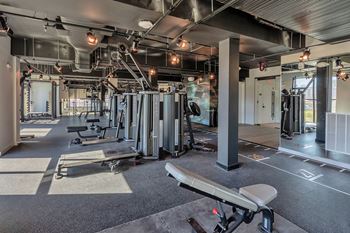 Professional fitness studio with Matrix equipment, Tonal all-in-one machines, Peloton training, lockers and mini refrigerators