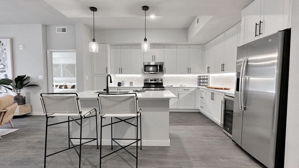 Fully-equipped kitchens with stainless steel appliances, wine coolers and 42" white cabinetry