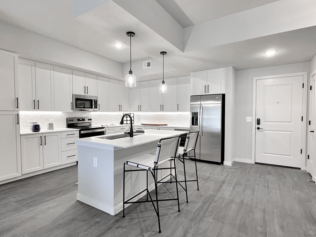 Matte black fixtures and hardware, trendy tile backsplashes and wine coolers in kitchen