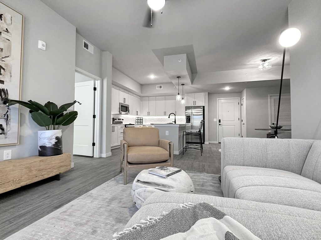 Living room with hardwood-inspired flooring in model