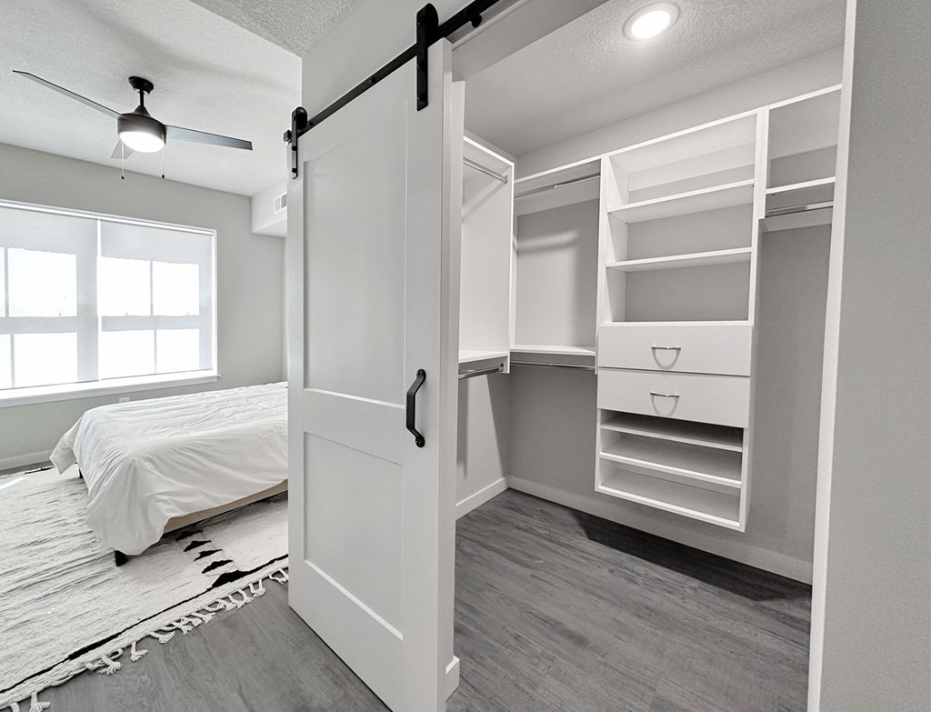 California-style walk-in closet and bedroom in model