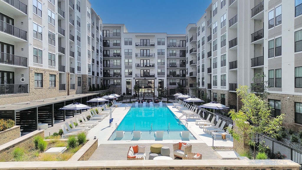 Heated knife-edge saltwater pool with sun shelves, cabanas, deck shower and water feature