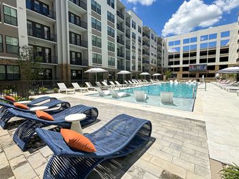 Heated knife-edge saltwater pool with sun shelves, cabanas, rain curtain, deck shower and water feature