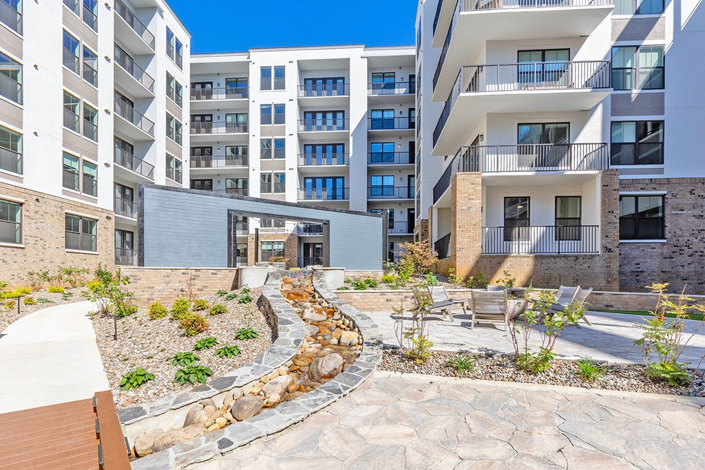 Zen garden courtyard with babbling brook and firepit