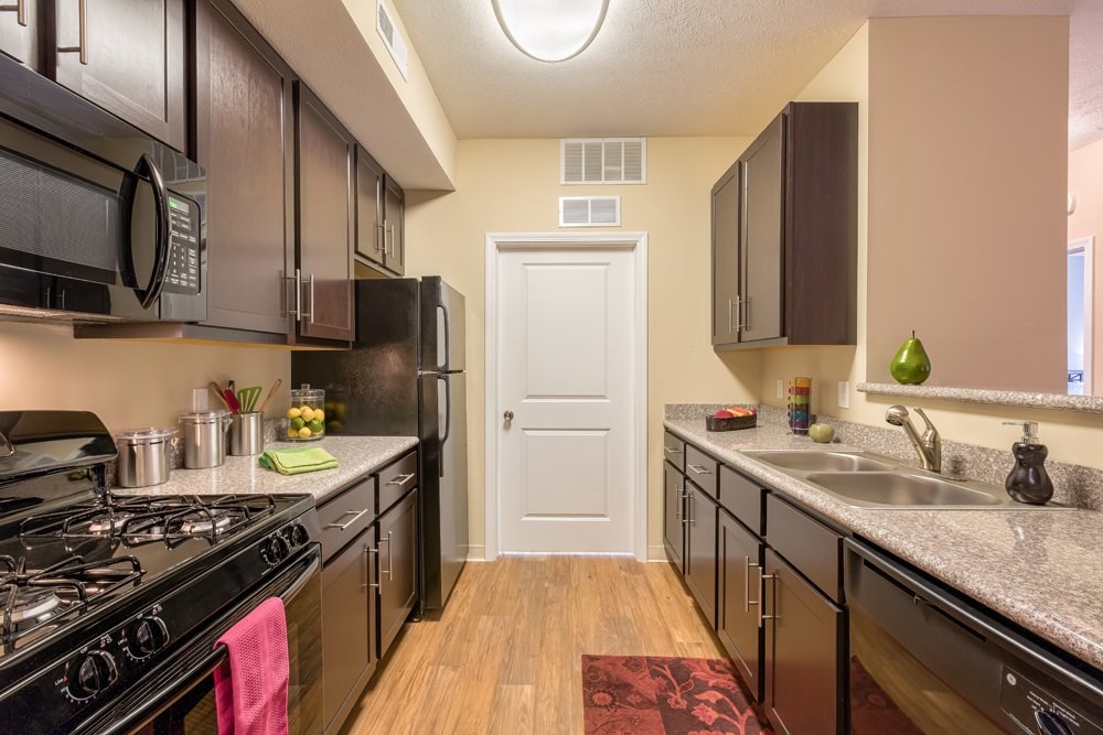 Granite countertops and 42” espresso finish custom cabinetry with contemporary brushed nickel hardware