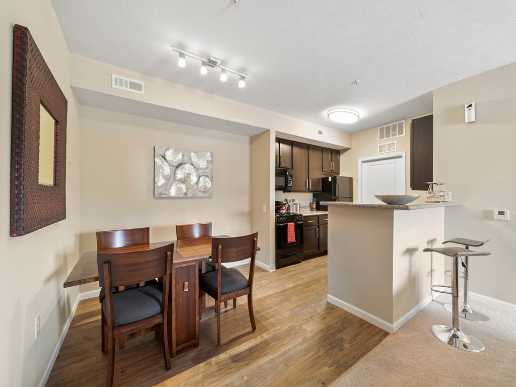 Large kitchens with granite countertops and hardwood-inspired flooring