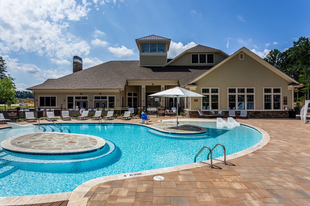 Beach-entry saltwater swimming pool with sundeck and cabanas