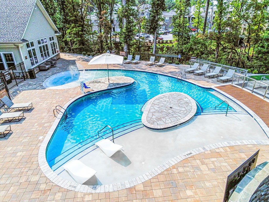 Beach-entry saltwater pool with sundeck and TV