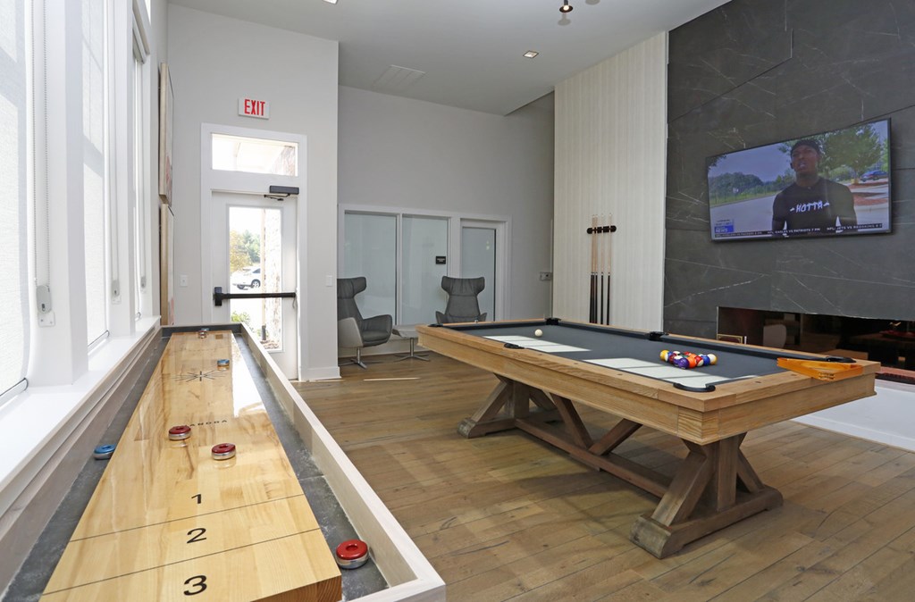 Gaming lounge with fireplace and TV