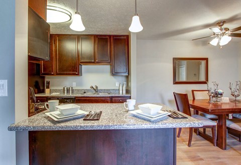 Renovated units with granite countertops and hardwood-inspired flooring in kitchens